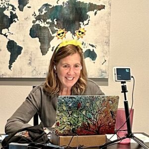 Kim at computer with headpiece